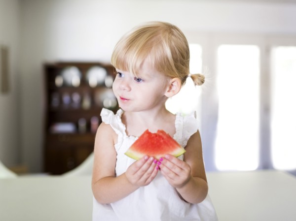 Portrait of girl (2-3) eating watermelon