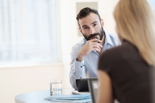 Man and woman sitting in office.