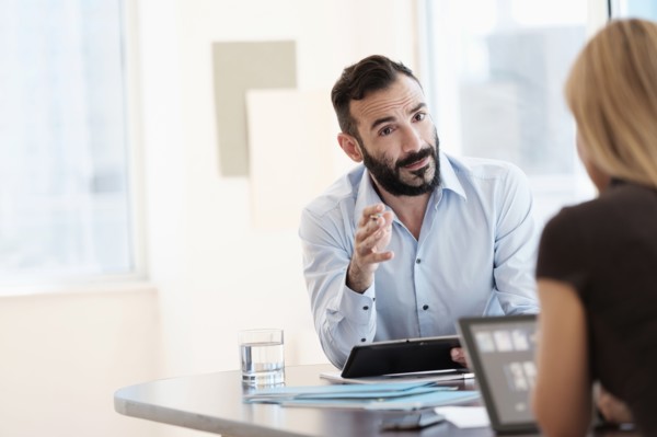 Man and woman talking in office.