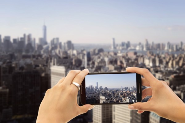 Hands photographing city. New York City, New York, USA.
