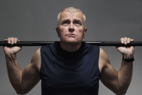 Man in health club weight lifting.