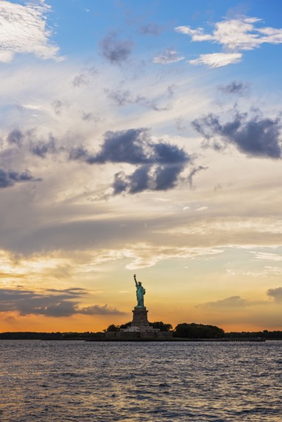 Silhouette of Statue of Liberty at sunset