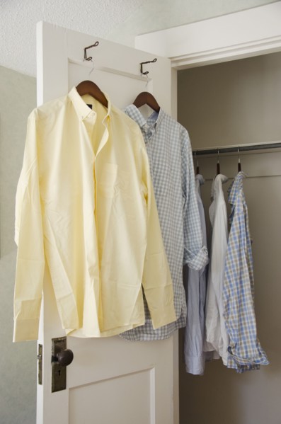 Button down shirts hanging on cloth hangers