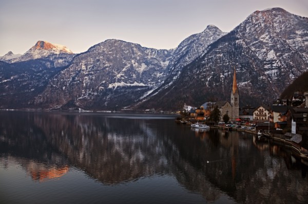 Town and mountains reflecting in lake