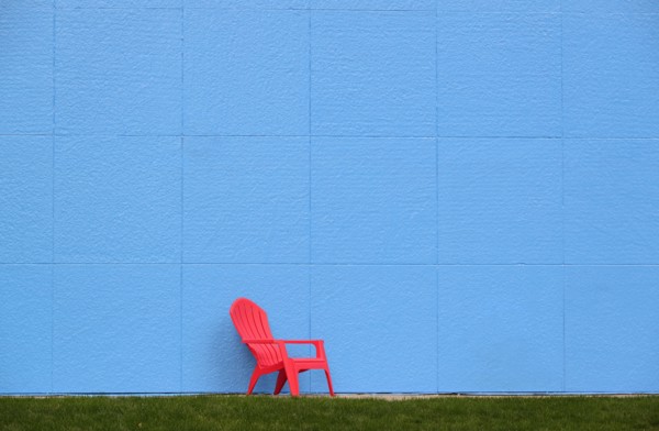 Red chair by blue wall