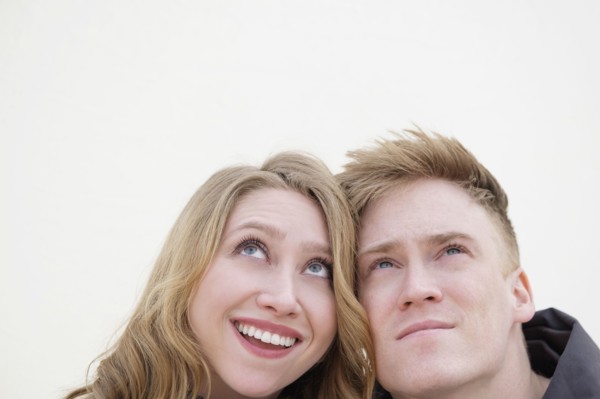 Young couple looking up.