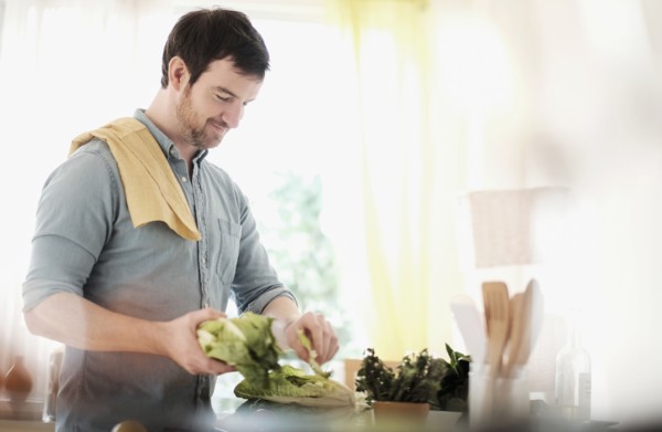 Man preparing food in kitchen.