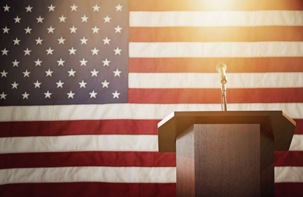 Lectern with American flag in background.