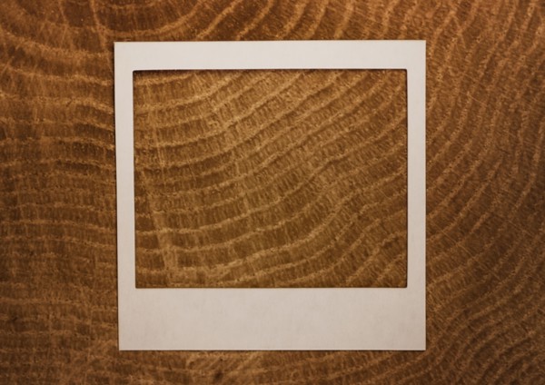 Empty Polaroid frame on wood