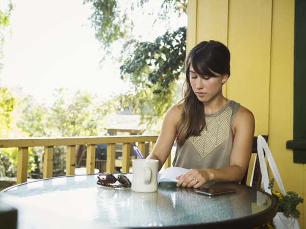Young woman writing in diary