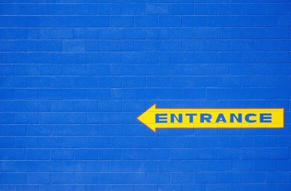 Blue wall with yellow entrance sign