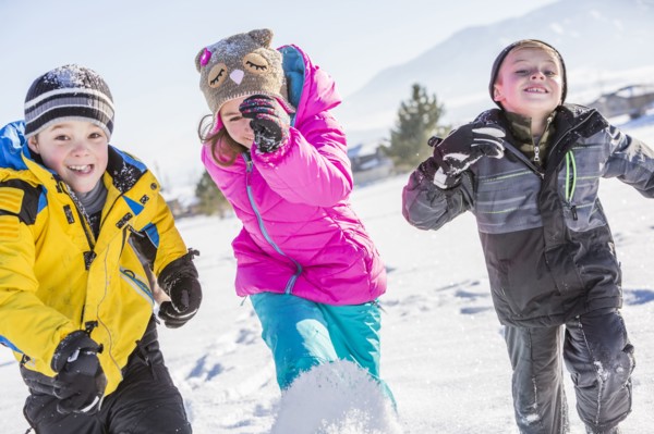 Children (8-9, 10-11) running in snow
