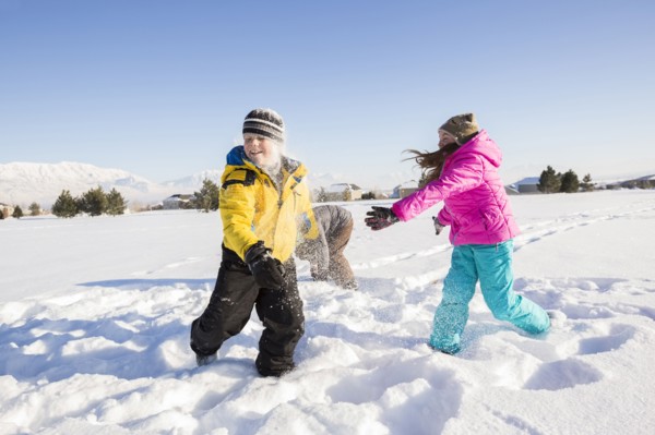 Children (8-9, 10-11) playing in snow