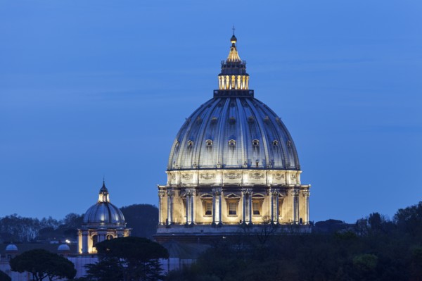 Illuminated St. Peter's Basilica at dusk