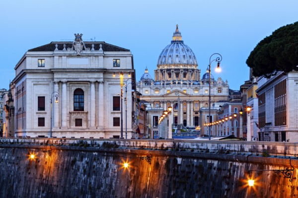 Illuminated St. Peter's Basilica at dusk