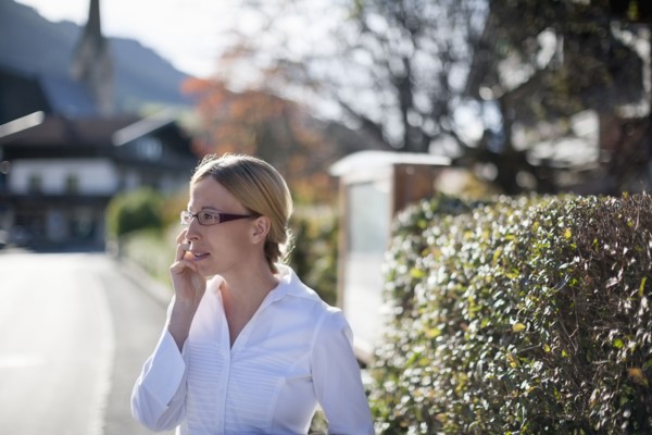 Woman wearing white shirt talking on phone