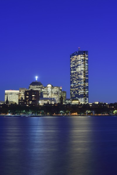 Illuminated waterfront buildings at dusk