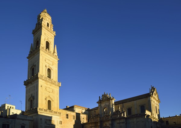 Bell tower and cathedral against clear sky
