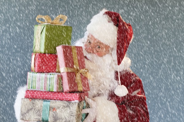 Portrait of Santa Claus carrying Christmas presents.