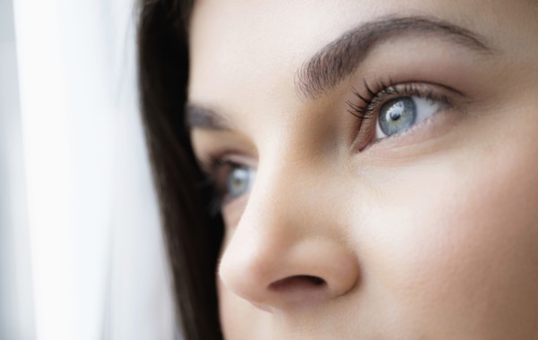 Close up of young woman with blue eyes.