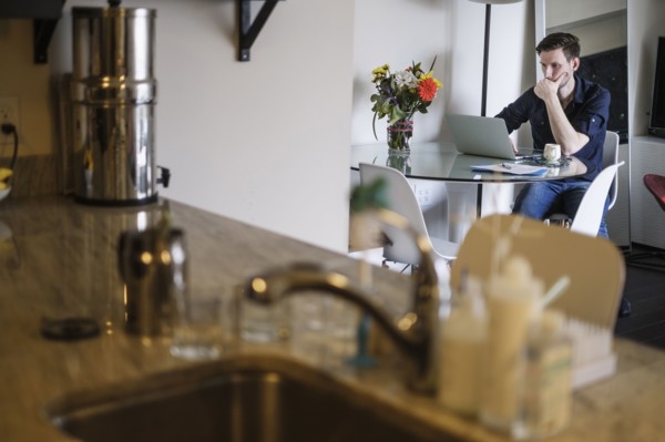 Man working on laptop at home.