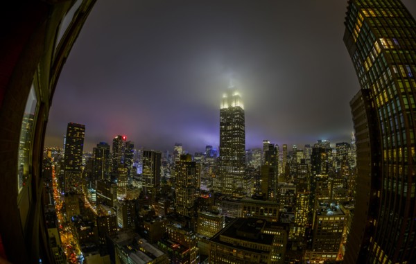 Empire State Building shrouded in night fog. USA, New York, New York City.