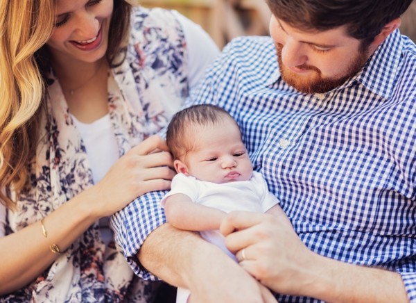 Happy parents holding girl (2-5 months)