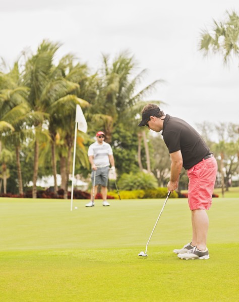 Two men playing golf