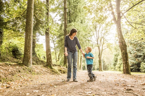 Mother walking with son (2-3) in park