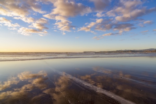 Cloudy sky reflected in sea