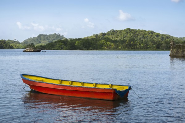 Boat on bay with green hills in background