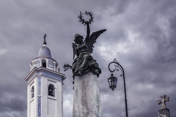 Statue and bell tower of Our Lady Del Pilar Church