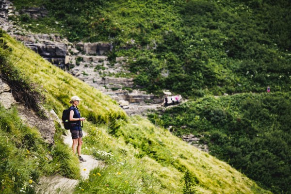 Mature woman standing on path in mountains