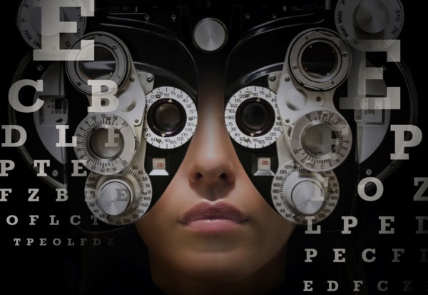 Woman looking through phoropter.