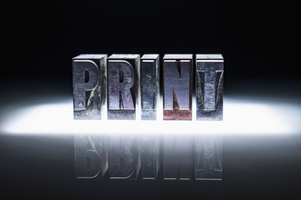 Word "PRINT" carved in blocks.