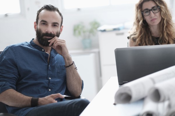 Man and woman talking in office.
