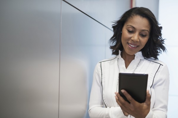 Portrait of woman holding digital tablet.