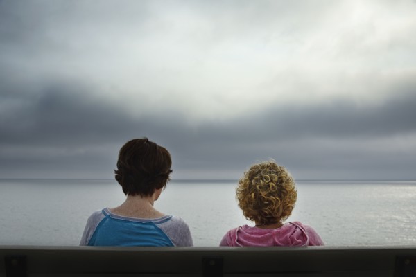 Massachusetts, Cape Cod, Truro, Rear view of two women sitting on bench and looking at sea