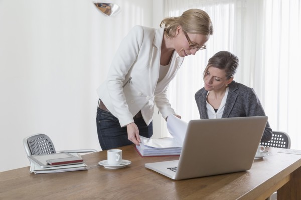Businesswomen looking at documents at office