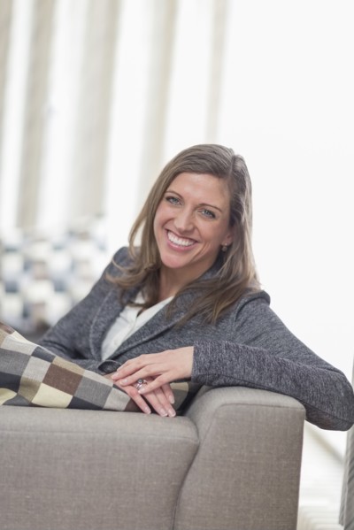 Smiling woman sitting on sofa