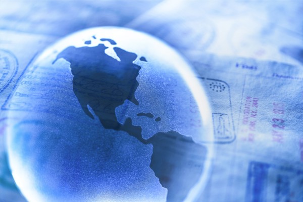 Stamps in passport and Planet Earth.