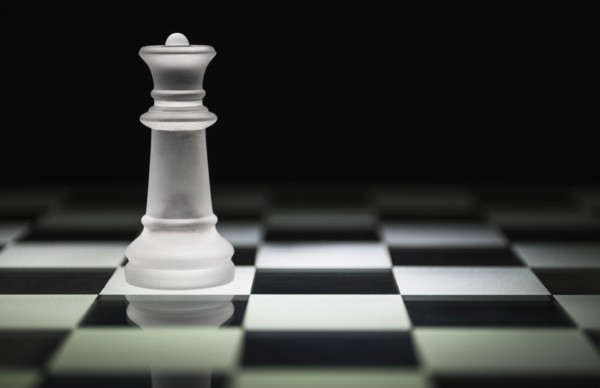 Chess queen on chess board.