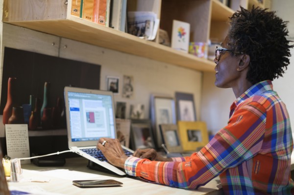 Woman using laptop in office.