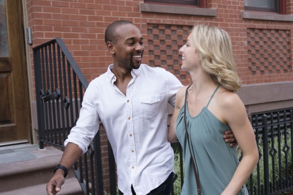 Smiling couple walking in residential district.