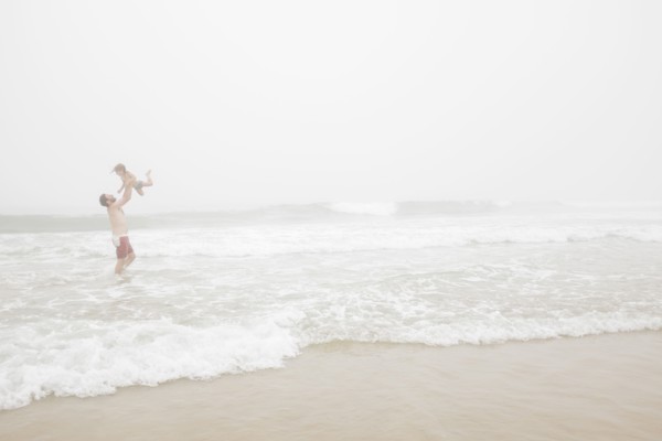 USA, New York, Monatuk, Father and daughter (2-3) on beach by ocean