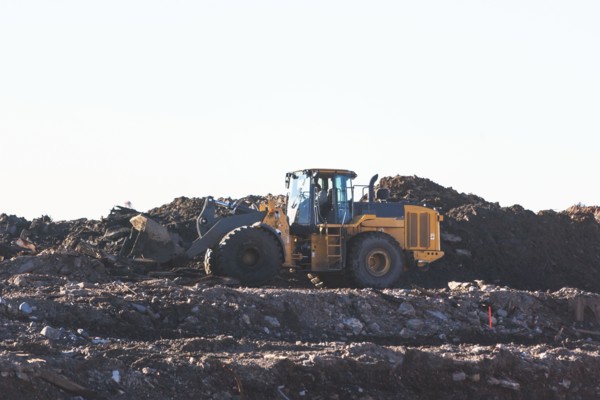 USA, New York State, New York City, Bulldozer on garbage dump