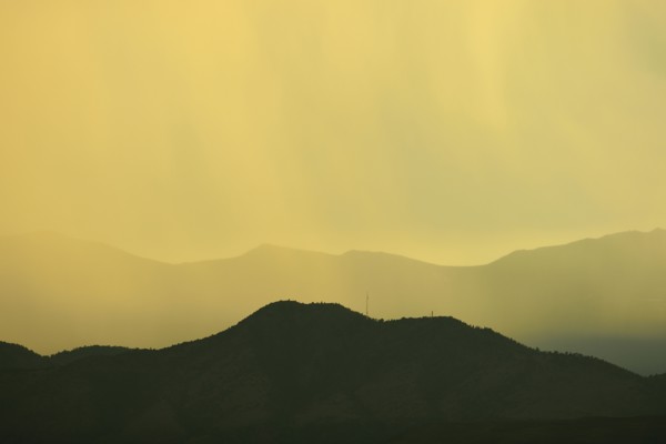 USA, Colorado, Denver, Rain against colorful sky above rocky mountains
