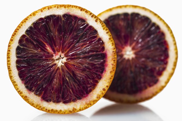 Two halves of red orange against white background