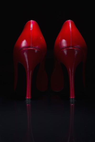 Red shoes against black background