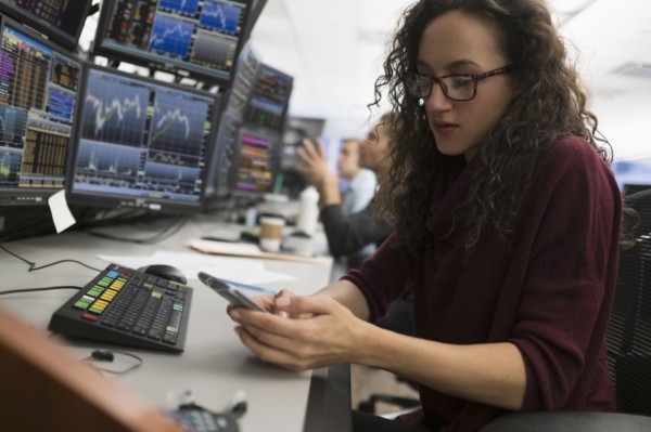 Young trader using mobile phone.